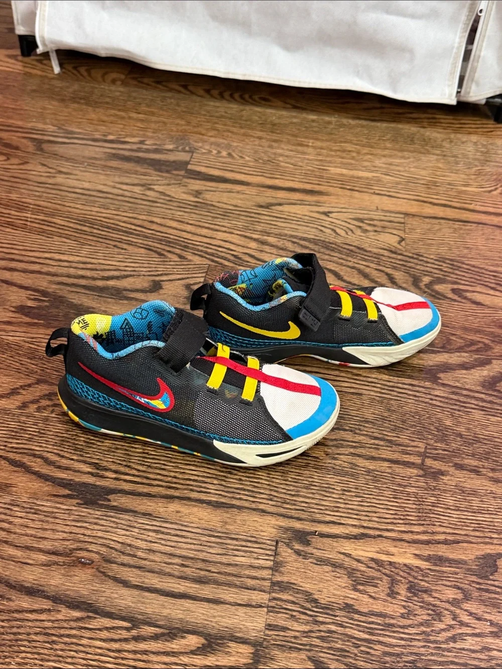 Nike Kids Black Sneakers with Blue, Red and Yellow Accents